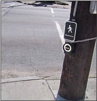 APS 
              was replaced on the pole, but the tactile arrow points to the center 
              of the intersection, rather than being aligned with the direction 
              of travel on the crosswalk.